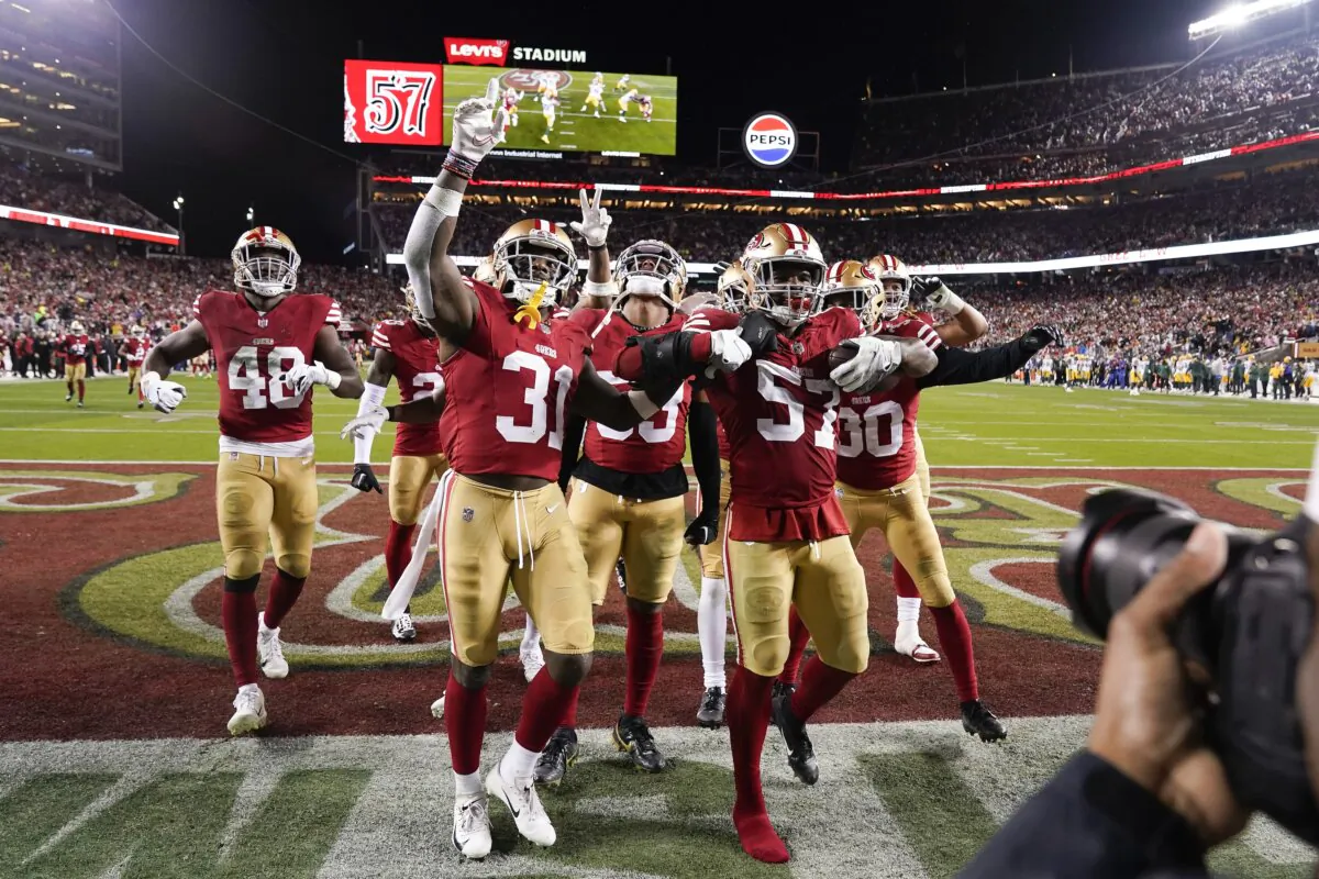 San Francisco 49ers linebacker Dre Greenlaw (57) celebrates with teammates after intercepting a pass during the second half an NFL football NFC divisional playoff game against the Green Bay Packers in Santa Clara, Calif., on Jan. 20, 2024. (Godofredo A. Vásquez/AP Photo)