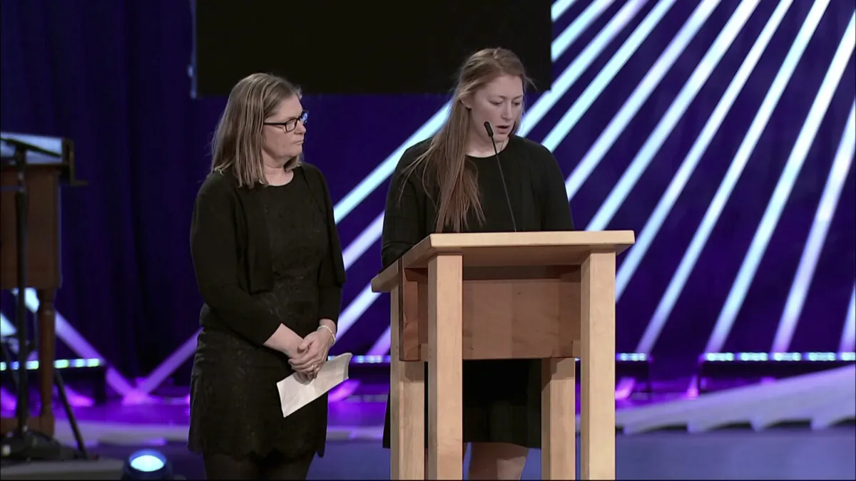 Elizabeth Marburger (L), wife of Dan Marburger, looks on as Claire Marburger, his daughter, speaks at his funeral in West Des Moines, Iowa, on Jan. 20, 2024. (Lutheran Church of Hope via AP)