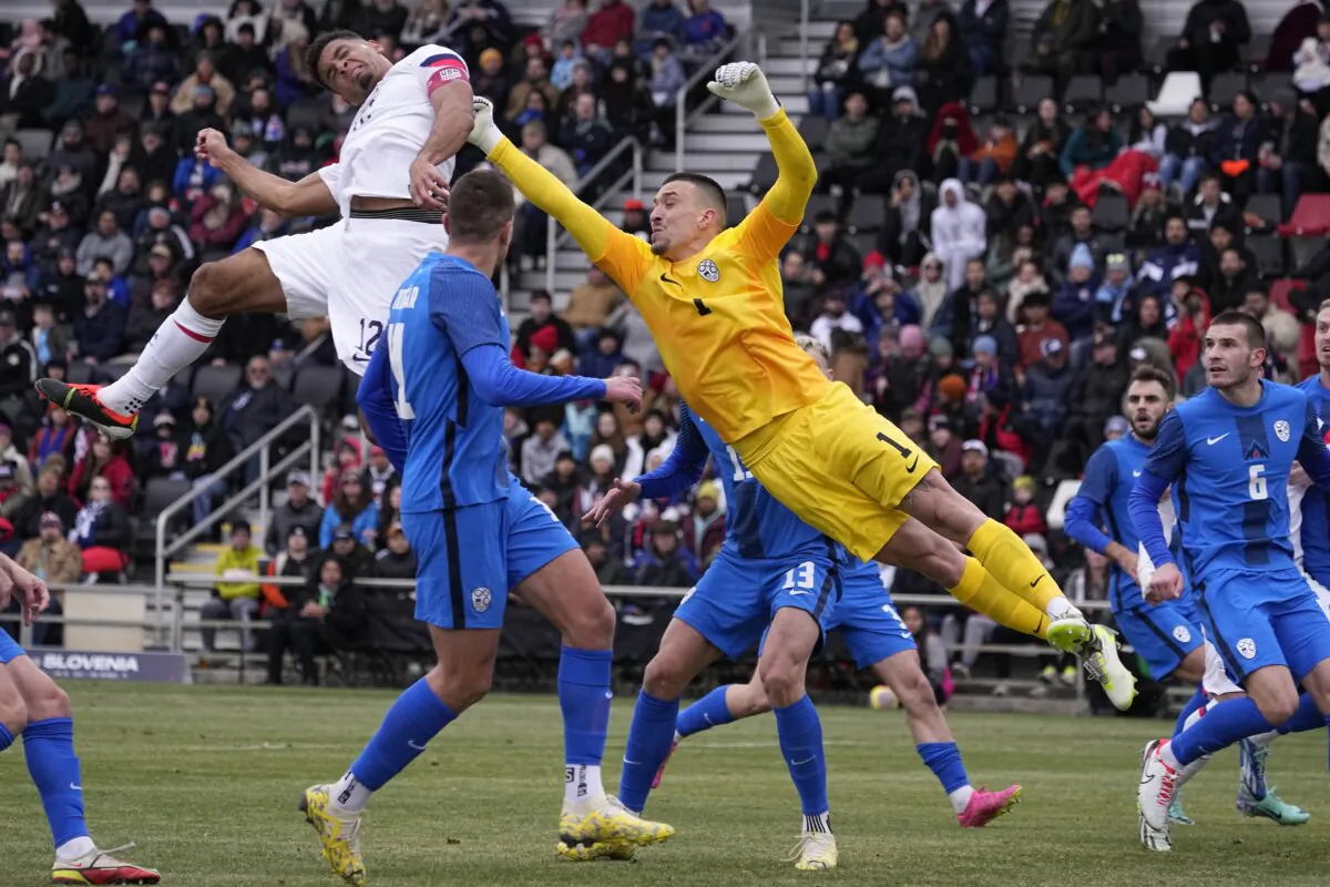 Slovenia goalkeeper Igor Vekic (1) and Klemen Mihelak defend a cross as United States' Miles Robinson (12) tries for a header during the first half of an international friendly soccer match in San Antonio on Jan. 20, 2024. (Eric Gay/AP Photo)