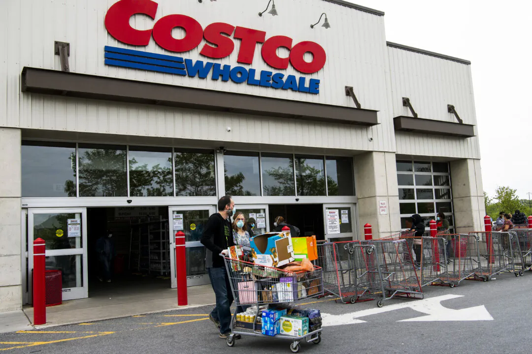 Shoppers walk out with full carts from a Costco store in Washington on May 5, 2020. (Nicholas Kamm/AFP via Getty Images)