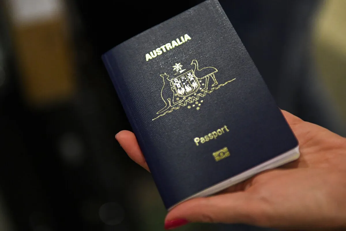 A traveler displays an Australian passport at Los Angeles International Airport  in Los Angeles, Calif., on Nov. 1, 2021. (Patrick T. Fallon/AFP via Getty Images)