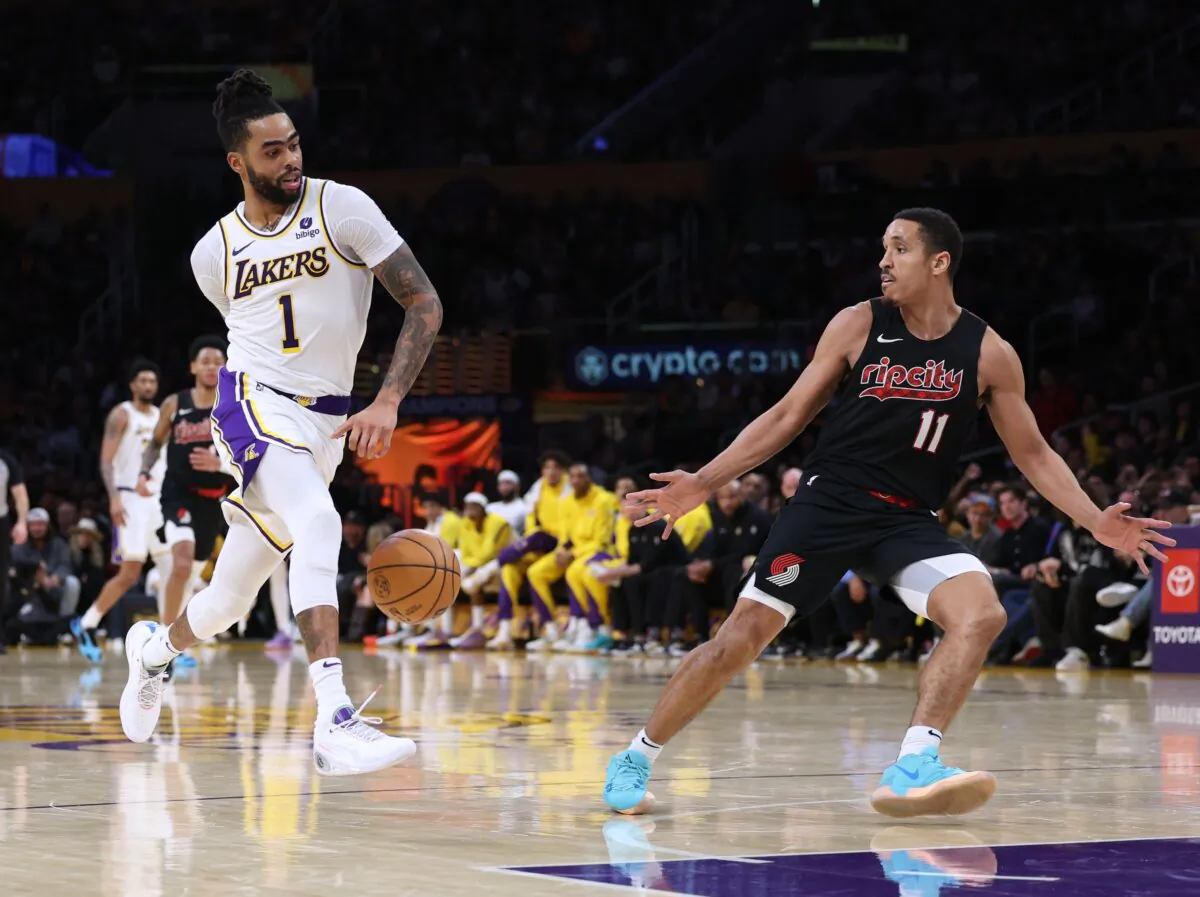 D'Angelo Russell (1) of the Los Angeles Lakers fakes a pass in front of Malcolm Brogdon (11) of the Portland Trail Blazers to score a layup during Lakers win in Los Angeles on Jan. 21, 2024. (Harry How/Getty Images)