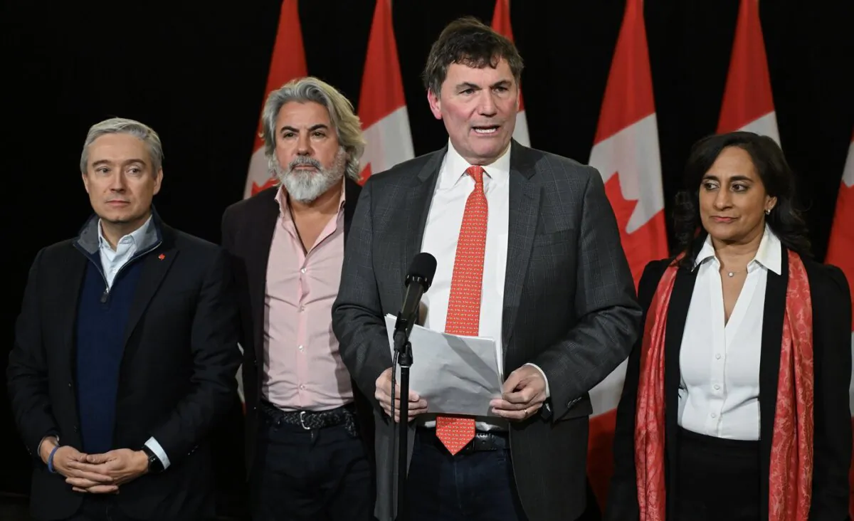 (L-R) Minister of Science and Innovation Francois-Philippe Champagne, Transport Minister Pablo Rodriguez, Public Safety Minister Dominic LeBlanc and Treasury Board President Anita Anand speak to reporters as they arrive for a cabinet retreat in Montreal, on Jan. 21, 2024. (The Canadian Press/Graham Hughes)