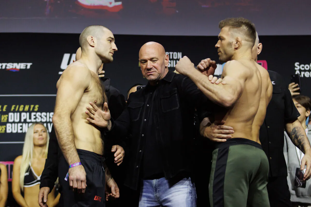 Sean Strickland, left, and Dricus Du Plessis are separated by UFC President Dana White during weigh-ins ahead of  UFC 297 in Toronto on Jan. 19, 2024.   (Cole Burston/The Canadian Press)