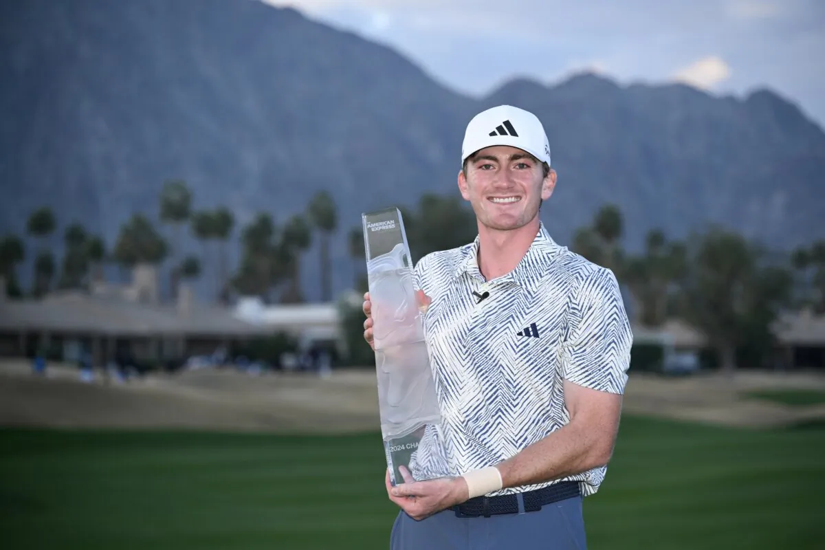 Nick Dunlap of the United States poses for a photo with the trophy after winning The American Express at Pete Dye Stadium Course in La Quinta, Calif., on Jan. 21, 2024. (Orlando Ramirez/Getty Images)