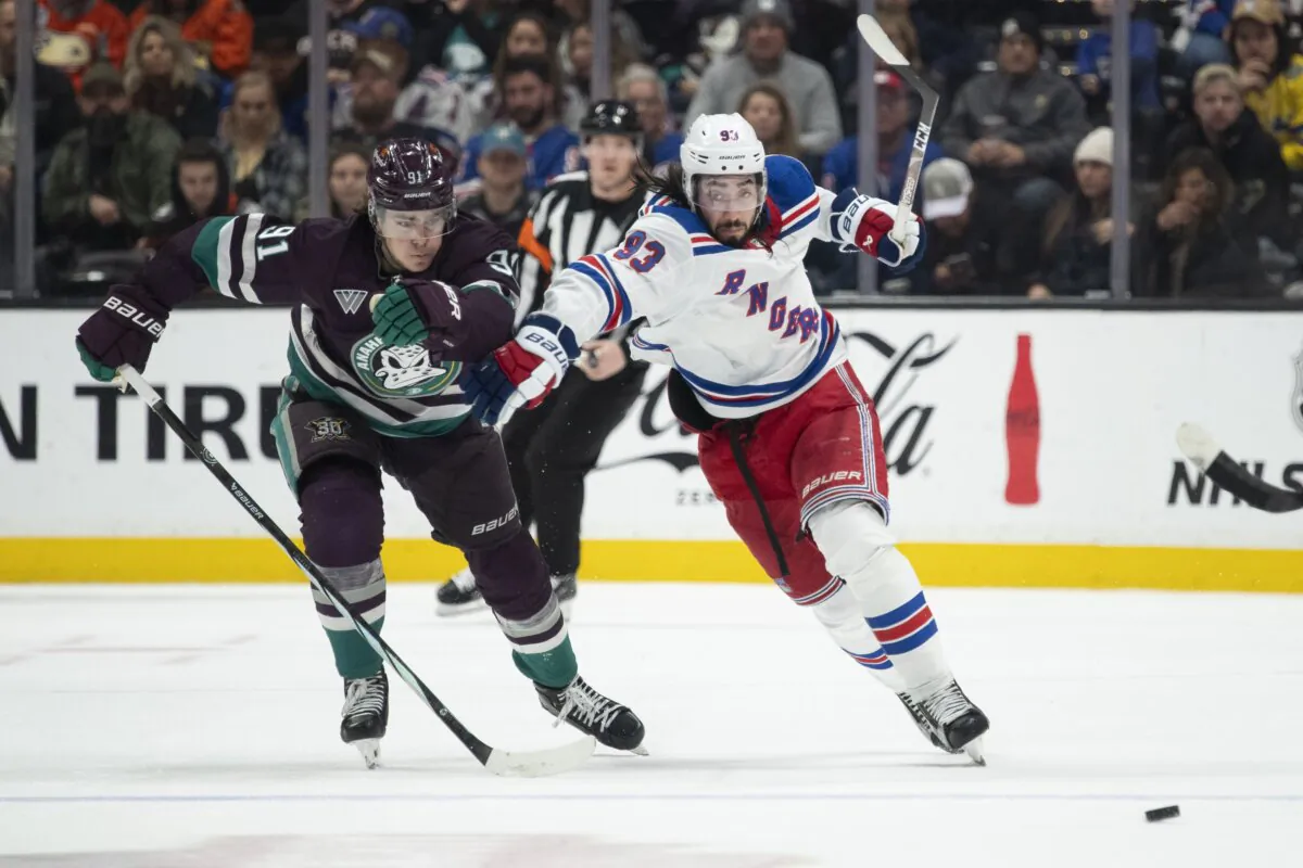 New York Rangers center Mika Zibanejad (93) and Anaheim Ducks center Leo Carlsson (91) vie for the puck during the second period of an NHL hockey game in Anaheim, Calif., on Jan. 21, 2024. (Kyusung Gong/AP Photo)