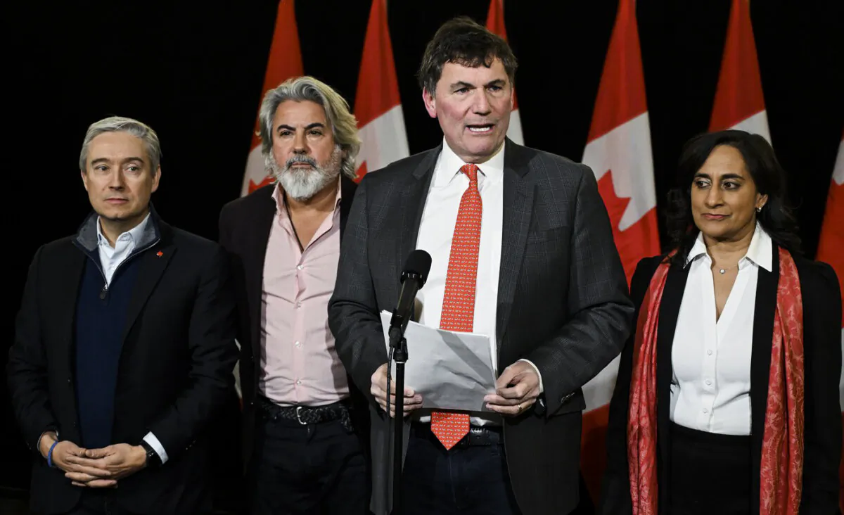 (L-R) Minister of Science and Innovation Francois-Philippe Champagne, Transport Minister Pablo Rodriguez, Public Safety Minister Dominic LeBlanc and Treasury Board President Anita Anand speak to reporters as they arrive for a cabinet retreat in Montreal, on Jan. 21, 2024. (The Canadian Press/Graham Hughes)