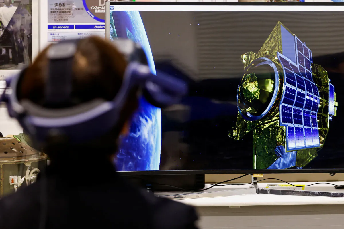 A journalist wearing a VR device tries a simulation of Smart Lander for Investigating Moon (SLIM)'s moon landing, at Japan Aerospace Exploration Agency (JAXA)'s facility, in Sagamihara, south of Tokyo, Japan, on Jan. 19, 2024. (Kim Kyung-Hoon/Reuters)