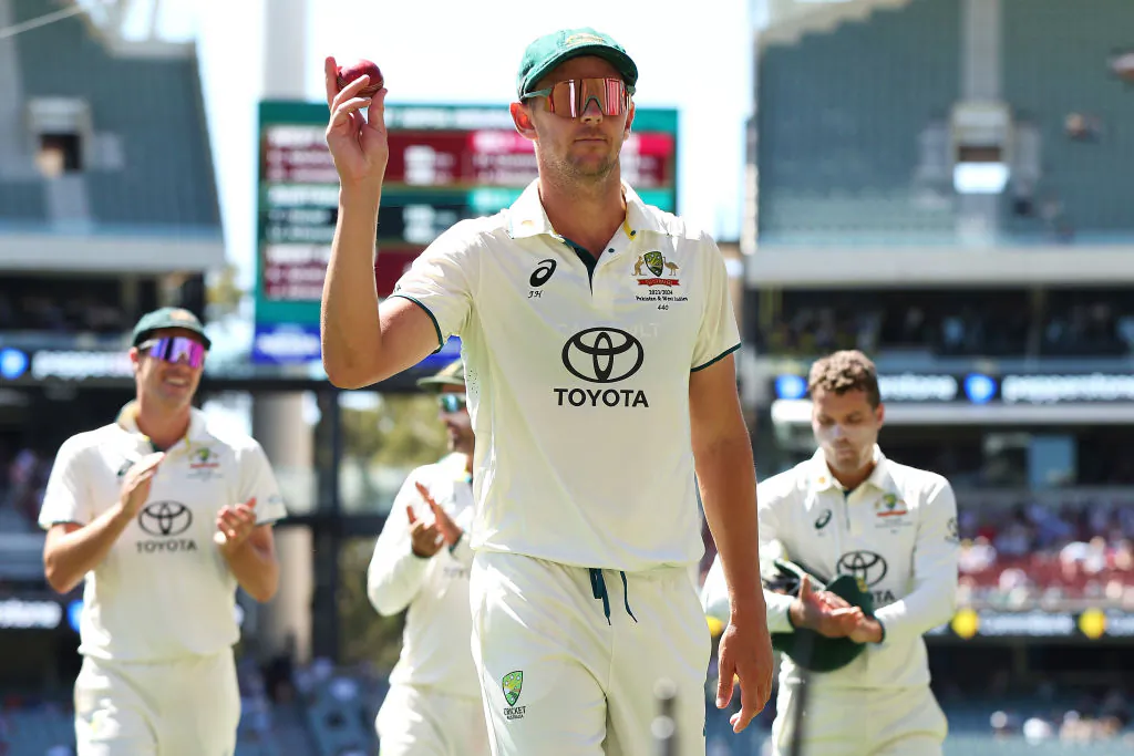 Josh Hazlewood of Australia holds up the match ball as he acknowledges the crowd after taking 5 wickets in the West Indies second innings during day three of the Mens Test match series between Australia and West Indies at Adelaide Oval in Adelaide, Australia, on Jan. 19, 2024. (Paul Kane/Getty Images)