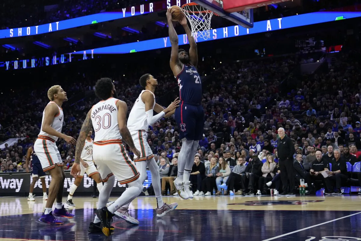 Philadelphia 76ers' Joel Embiid (R) goes up for a dunk past San Antonio Spurs' Victor Wembanyama during the first half of an NBA basketball game in Philadelphia on Jan. 22, 2024. (Matt Slocum/AP Photo)