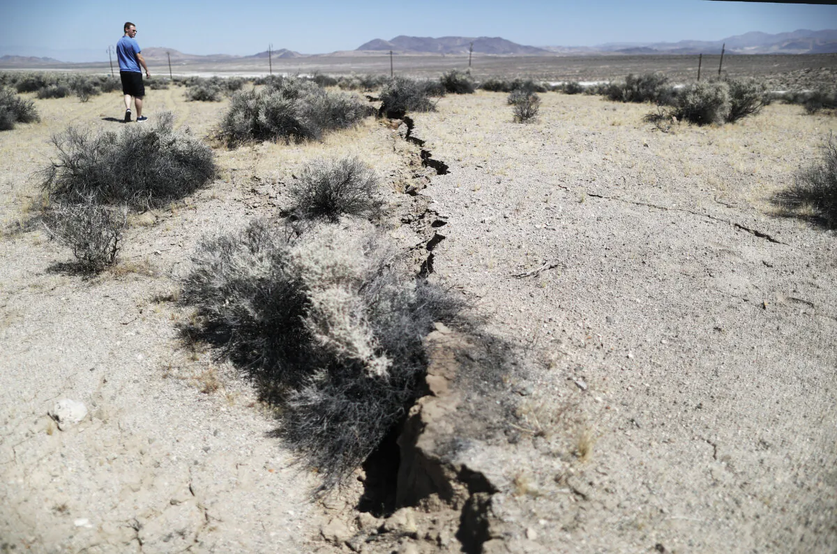 An onlooker views newly ruptured ground after a 7.1 magnitude earthquake struck in the area on July 6, 2019. near Ridgecrest, Calif. The earthquake, which occurred July 5th, was the second large quake to hit the area in two days and the largest in Southern California in 20 years. (Mario Tama/Getty Images)