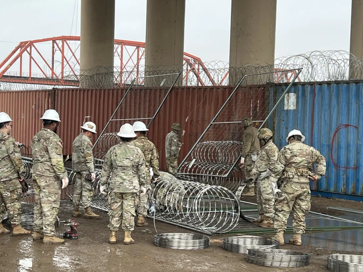 Texas National Guard members prepare to install barriers at Shelby Park on the U.S.–Mexico border, in Eagle Pass, Texas, on Jan. 23, 2024. (Charlotte Cuthbertson/The Epoch Times)
