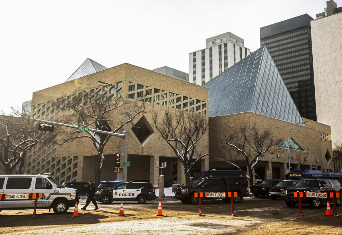 Police surround city hall during an investigation, in Edmonton, on Jan. 23, 2024. (The Canadian Press/Jason Franson)