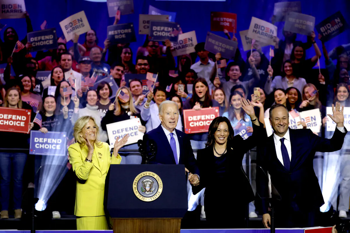 (L-R) First Lady Jill Biden, President Joe Biden, Vice President Kamala Harris, and Second Gentleman Douglas Emhoff join hands as they depart a Reproductive Freedom Campaign Rally at George Mason University in Fairfax, Va., on Jan. 23, 2024. (Anna Moneymaker/Getty Images)