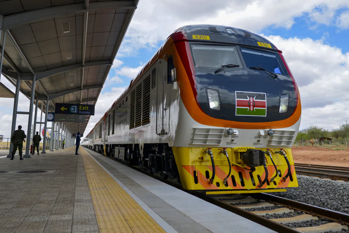 One of Kenya's newly acquired standard gauge rail locomotive, carrying the Kenyan president pulls into Voi railway station on May 31, 2017 in Voi, during an inaugural ride on Kenya's new standard gauge railway from the coastal city of Mombasa to the capital, Nairobi.
Kenya's President Uhuru Kenyatta on Wednesday inaugurated a Chinese-built railway, the country's biggest infrastructure project since independence that is aimed at cementing its role as the gateway to East Africa. Cheering crowds waved at the passenger train as it sped past on its maiden journey from the port city of Mombasa / AFP PHOTO / TONY KARUMBA (Photo credit should read TONY KARUMBA/AFP via Getty Images)
