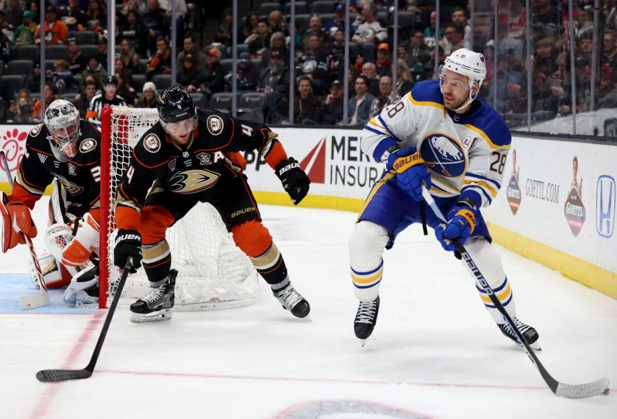 Cam Fowler (4) and John Gibson (36) of the Anaheim Ducks defend Zemgus Girgensons (28) of the Buffalo Sabres during the third period in a Ducks win in Anaheim, Calif., on January 23, 2024. (Harry How/Getty Images)