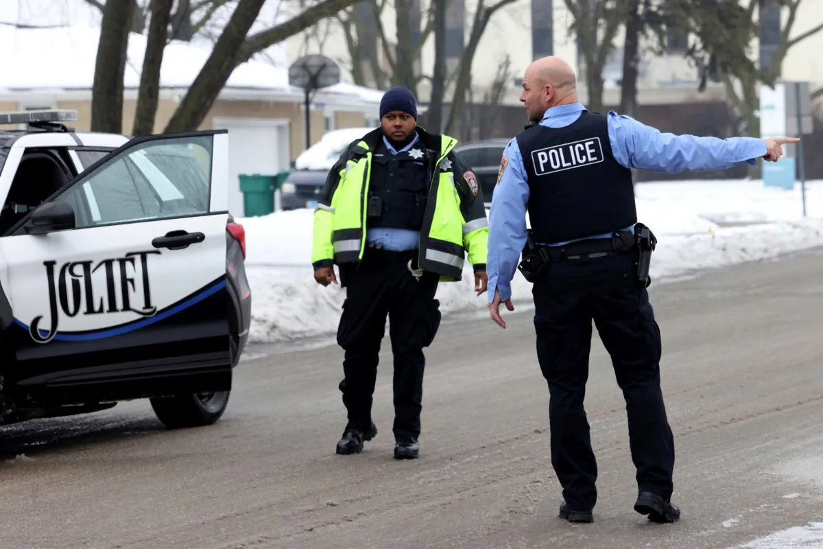 Joliet police officers work at the scene where multiple people were shot to death in suburban Chicago on Jan. 23, 2024. (Antonio Perez/Chicago Tribune via AP)