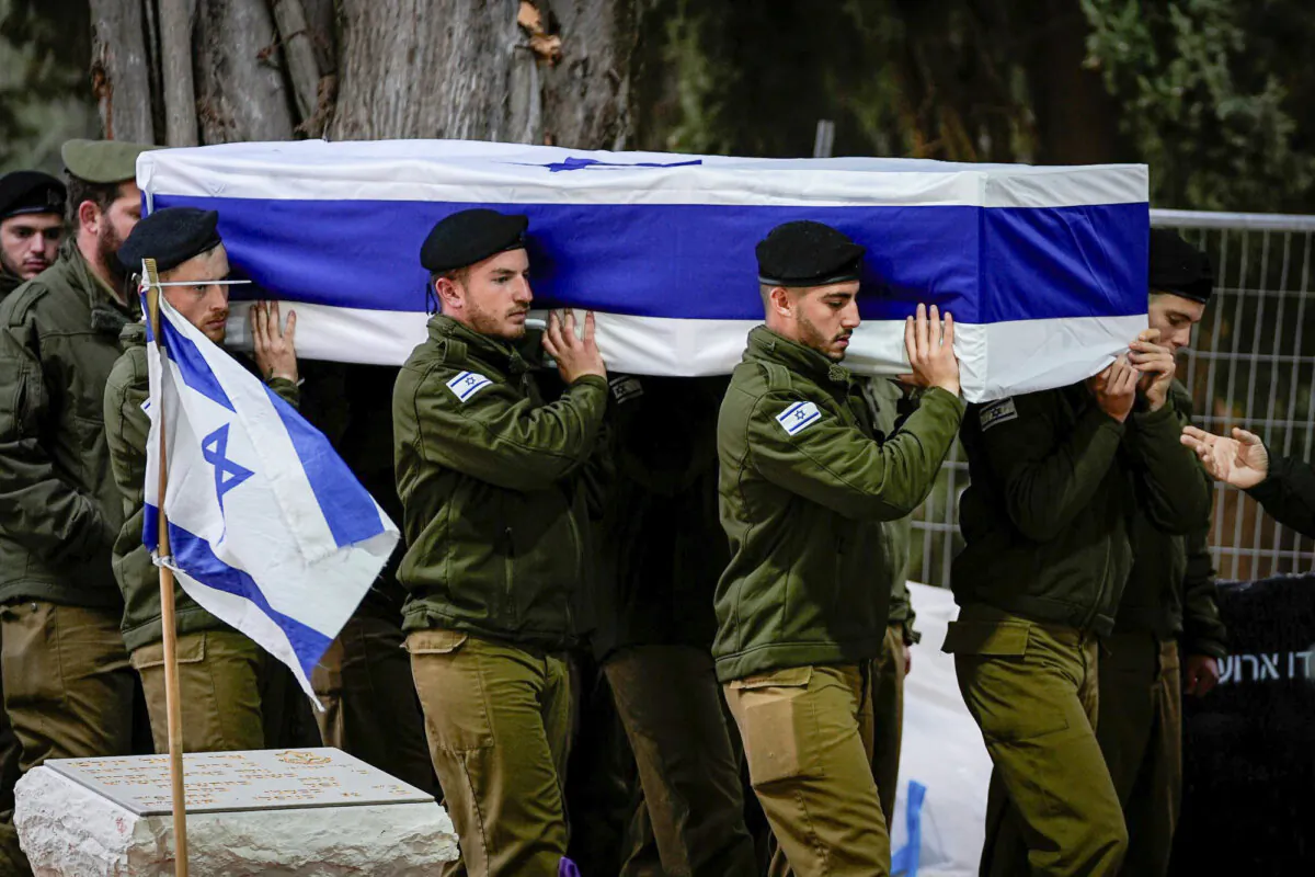 Israeli soldiers carry the flag-draped casket of reservist Hadar Kapeluk during his funeral at Mt. Herzl military cemetery in Jerusalem, on Jan. 23, 2024. (Ohad Zwigenberg/AP Photo)