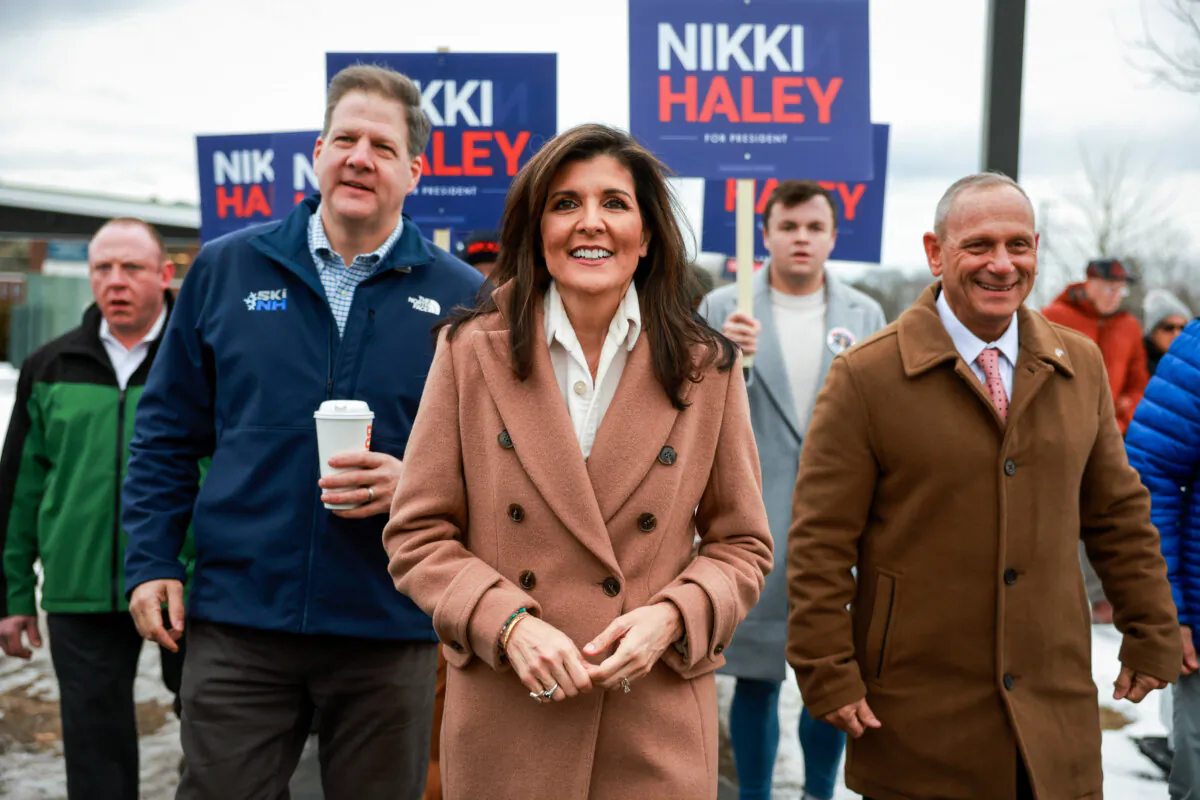 Republican presidential candidate, former U.N. Ambassador Nikki Haley is joined by New Hampshire Gov. Chris Sununu as they visit a polling location at Winnacunnet High School in Hampton, N.H, to greet voters on Jan. 23, 2024. (Joe Raedle/Getty Images)