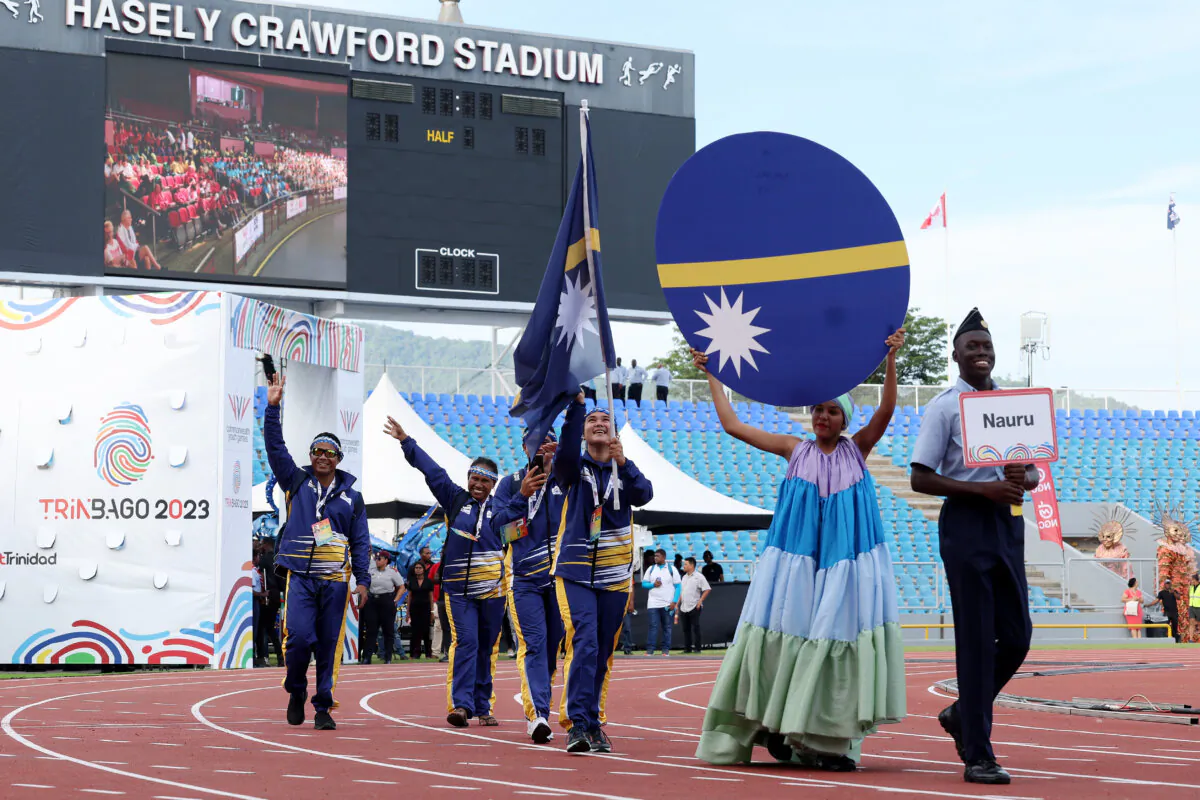 Flag Bearers of Team Nauru lead the team out during the Opening Ceremony of the 2023 Youth Commonwealth Games at Hasely Crawford Stadium in Port of Spain, Trinidad And Tobago, on Aug. 4, 2023. (Jamie Squire/Getty Images for Commonwealth Sport)