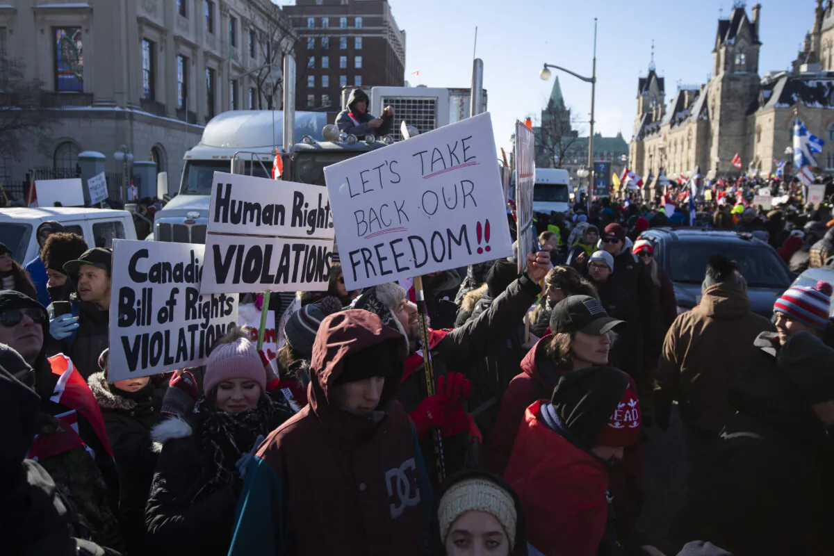 People participate in a Freedom Convoy rally protesting the federal vaccine mandate for truckers and other pandemic restrictions, in Ottawa on Jan. 29, 2022. (The Canadian Press/Justin Tang)
