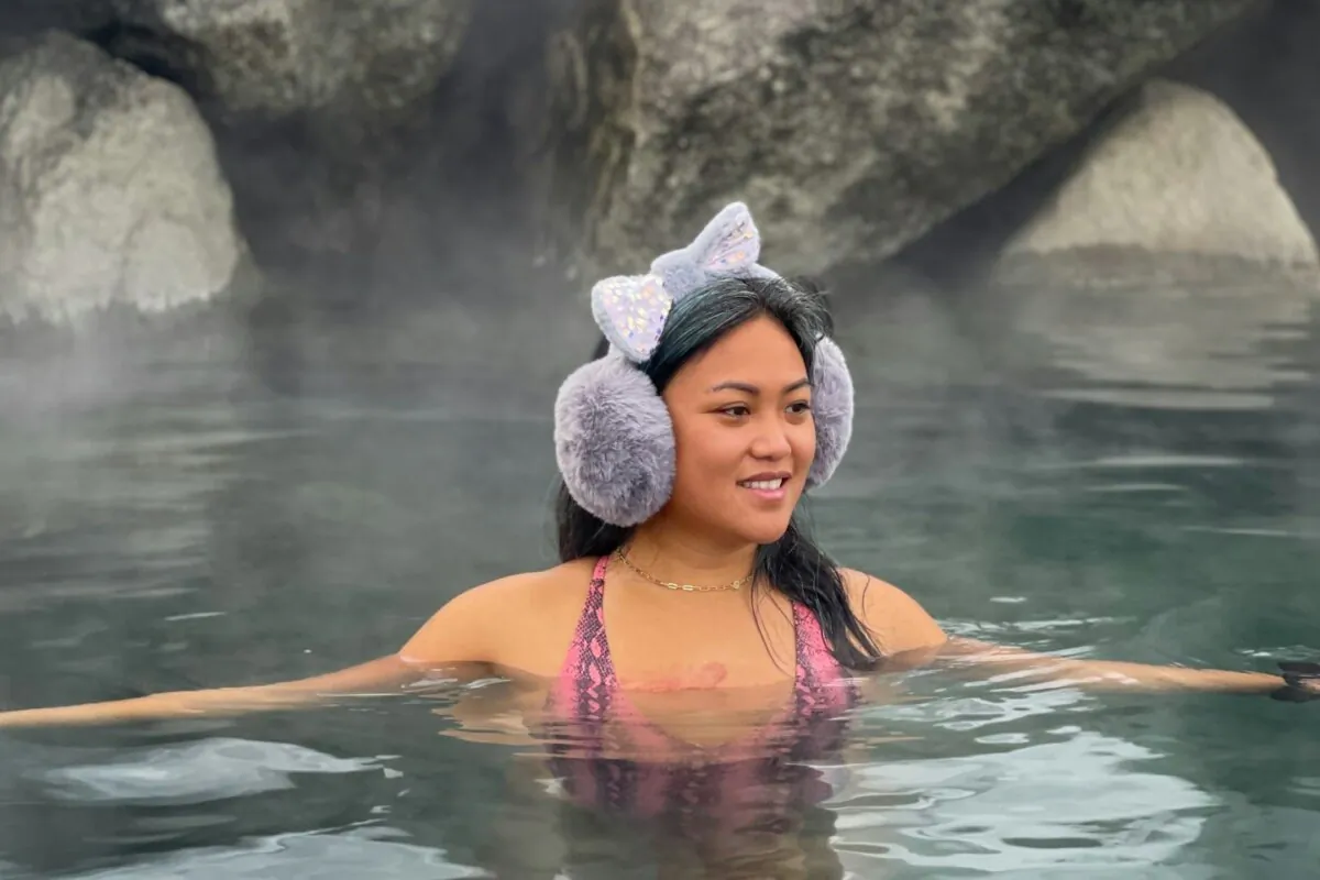 A woman soaks in a hot spring in a file photo. (Alexandra Tran/Unsplash)