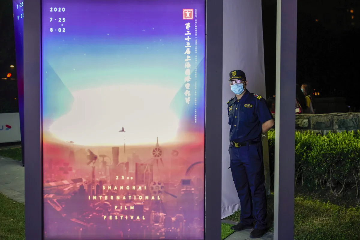 A security man wearing a protective mask looks during an outdoor screening event in Shanghai, China, on July 25, 2020. (Yifan Ding /Getty Images)