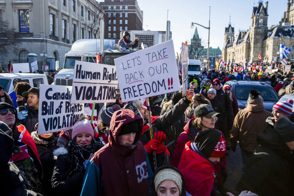 People participate in a rally against COVID-19 restrictions on Parliament Hill, which began as a cross-country convoy protesting a federal vaccine mandate for truckers, in Ottawa, on Jan. 29, 2022. (The Canadian Press/Justin Tang)