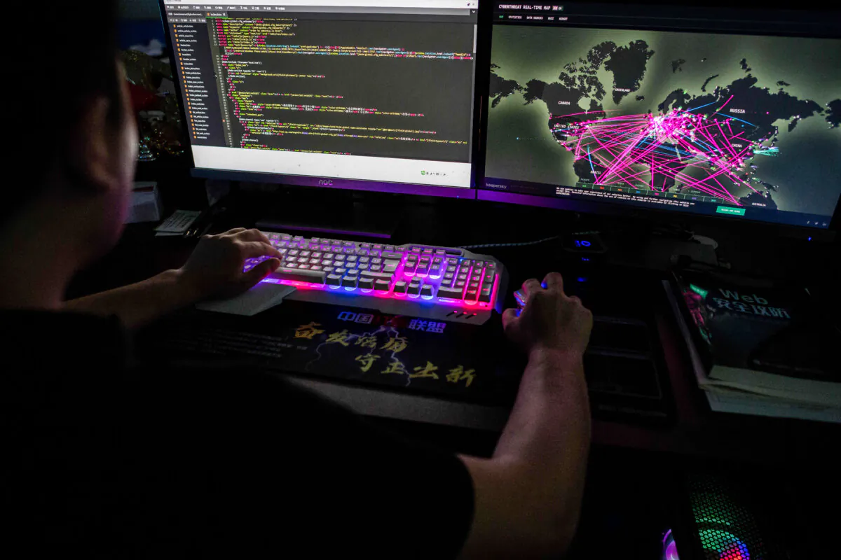 A member of the hacking group Red Hacker Alliance who refused to give his real name, uses a website that monitors global cyberattacks on his computer at the group's office in Dongguan, Guangdong Province, China, on Aug. 4, 2020. (Nicolas Asfouri/AFP via Getty Images)