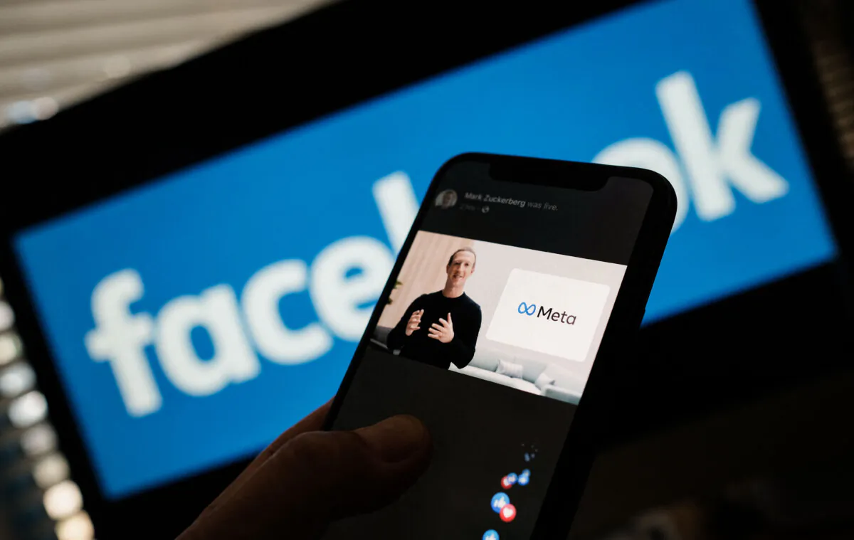 A smartphone displays Facebook CEO Mark Zuckerberg unveiling the Meta logo, in Los Angeles on Oct. 28, 2021. (Chris Delmas/AFP via Getty Images)