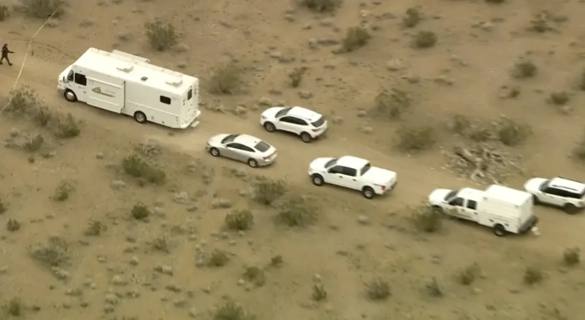 This aerial still image from video provided by KTLA shows law enforcement vehicles where several people were found shot to death in El Mirage, Calif. on Jan. 24, 2024. (KTLA via AP)