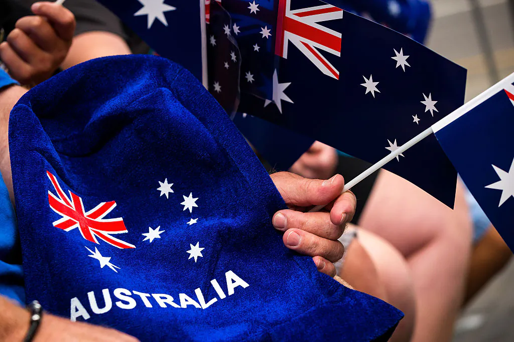 People wave flags and festive merchandise to celebrate Australia Day in Melbourne, Australia, on Jan. 26, 2017. (Chris Hopkins/Getty Images)