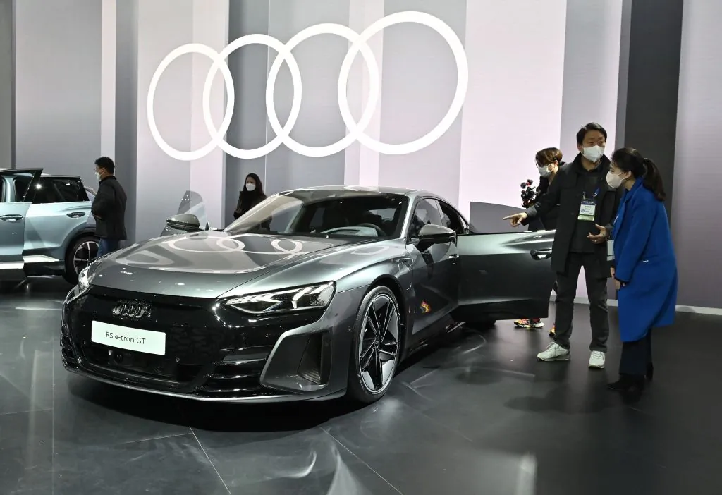 Visitors look at Audi's RS e-tron GT car during a press preview of the Seoul Mobility Show at KINTEX exhibition hall in Goyang on November 25, 2021. (Photo by Jung Yeon-je / AFP) (Photo by JUNG YEON-JE/AFP via Getty Images)