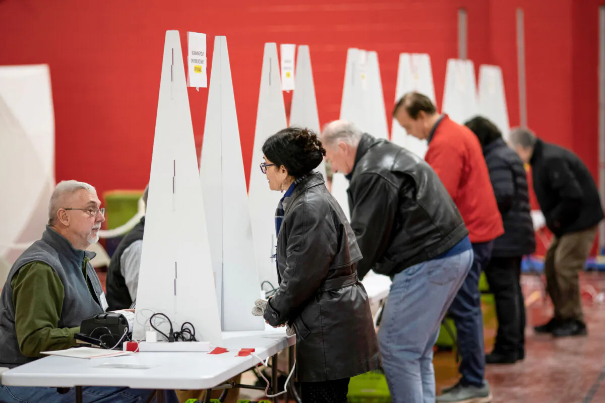 Voters check in to cast ballots in the New Hampshire presidential primary at a polling site in Derry, N.H., on Jan. 23, 2024. (David Goldman/AP Photo)