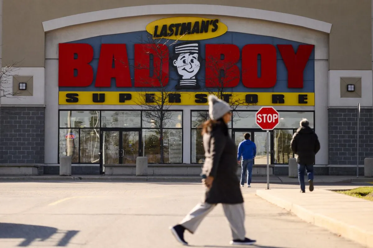 People walk past a Bad Boy furniture store, in Brampton, Ont., on Nov., 13, 2023. (The Canadian Press/Christopher Katsarov)