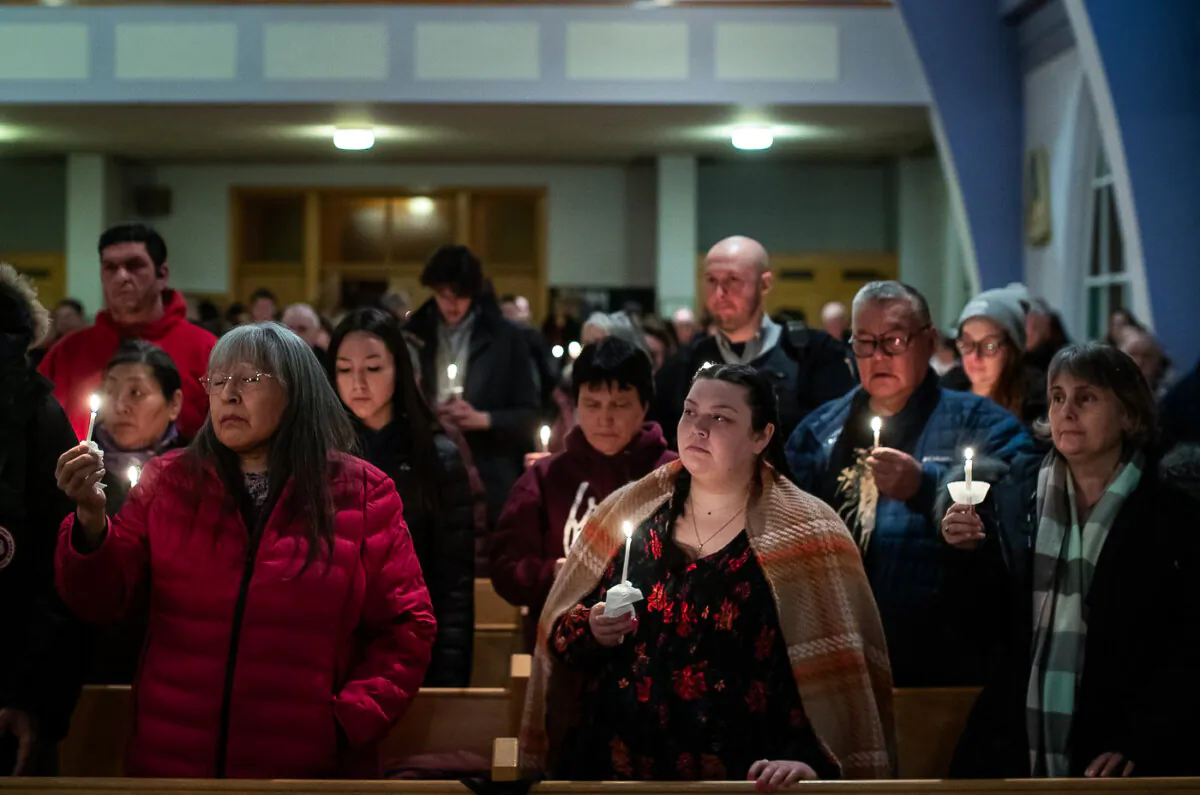 Community members gather and hold a vigil for the six people killed in a plane crash, in Fort Smith, Northwest Territories, on Jan. 24, 2024. (The Canadian Press/Jason Franson)