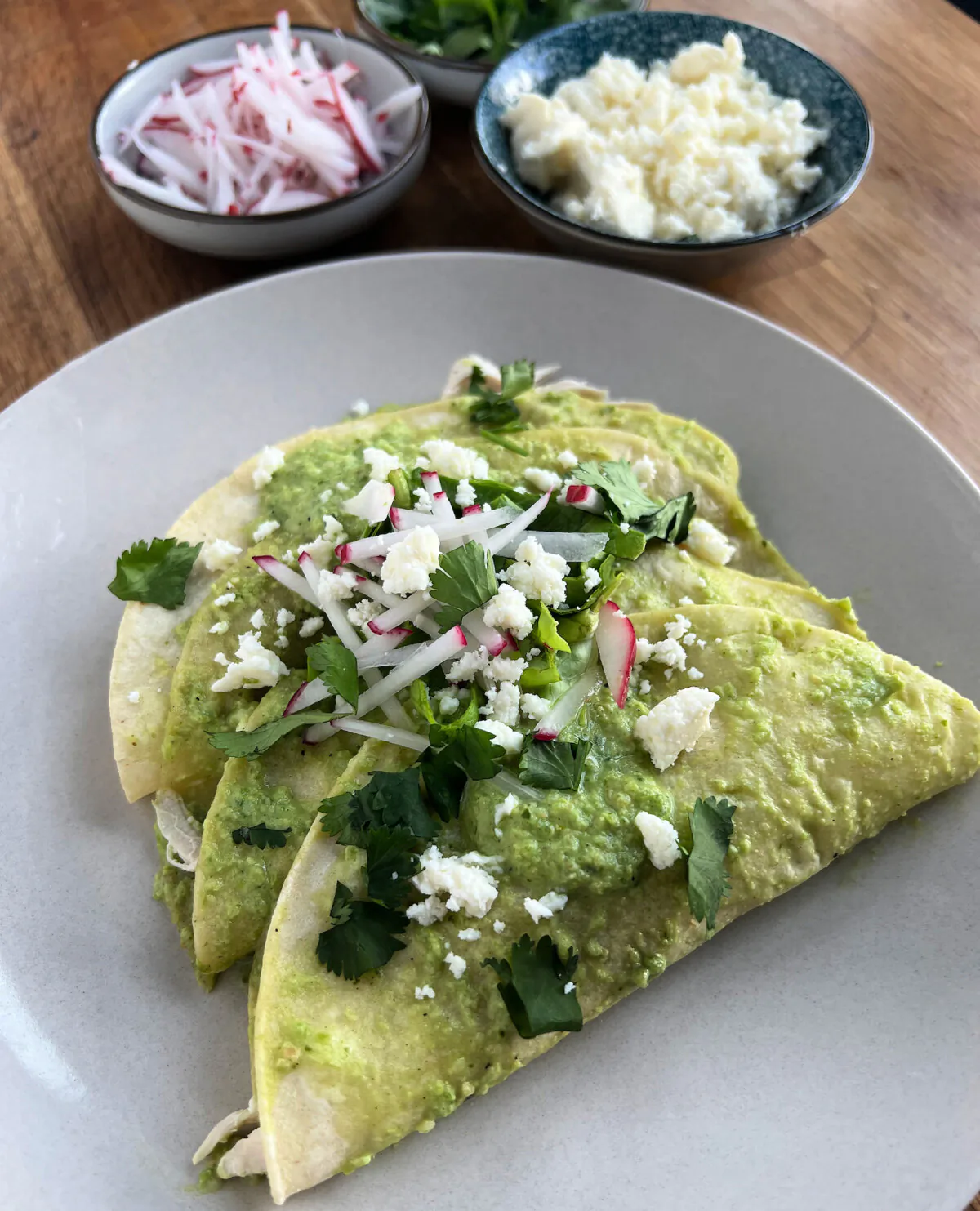 Chicken enchiladas topped with a spicy roasted poblano sauce and crumbled queso fresco. (Gretchen McKay/Post-Gazette)