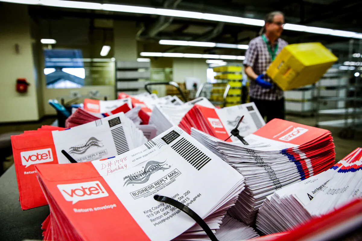 Empty envelopes of opened vote-by-mail ballots for the presidential primary are stacked on a table at King County Elections in Renton, Wash., on March 10, 2020. (Jason Redmond/AFP via Getty Images)