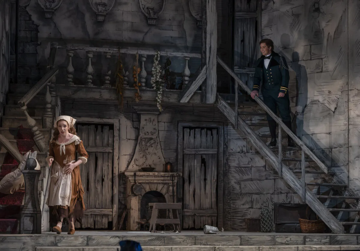 Angelina (Vasilisa Berzhanskaya) cleans as Prince Ramiro (Jack Swanson) eavesdrops on her, in "Cinderella." (Michael Brosilow)