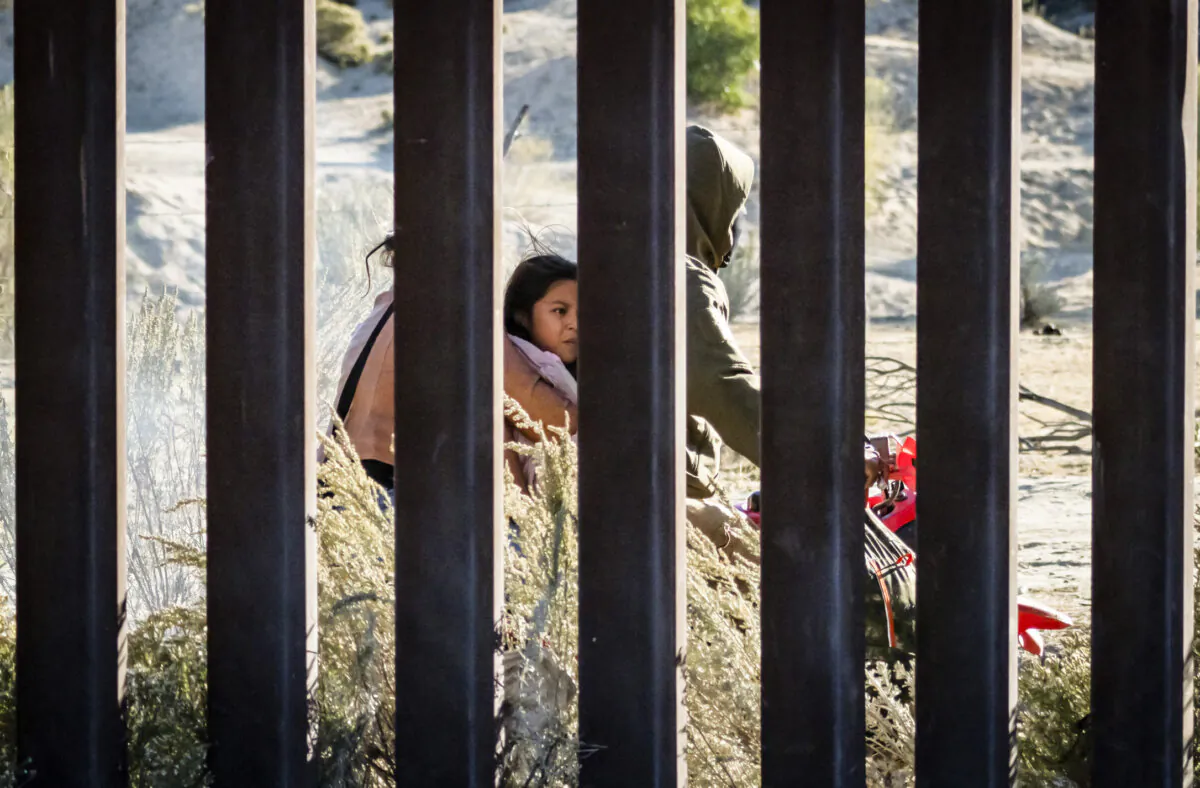 Human smugglers drive thier ATV's on the Mexicacn side of the United States border wall near Jacumba, Calif., on Oct. 31, 2023. (John Fredricks/The Epoch Times)