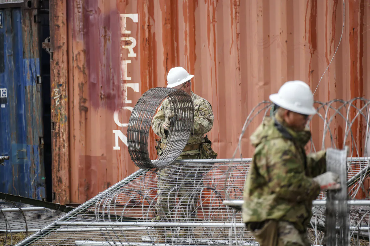 Texas National Guardsmen add razor wire and barriers along the U.S.–Mexico border in Shelby Park, Eagle Pass, Texas, on Jan. 23, 2024. (Charlotte Cuthbertson/The Epoch Times)