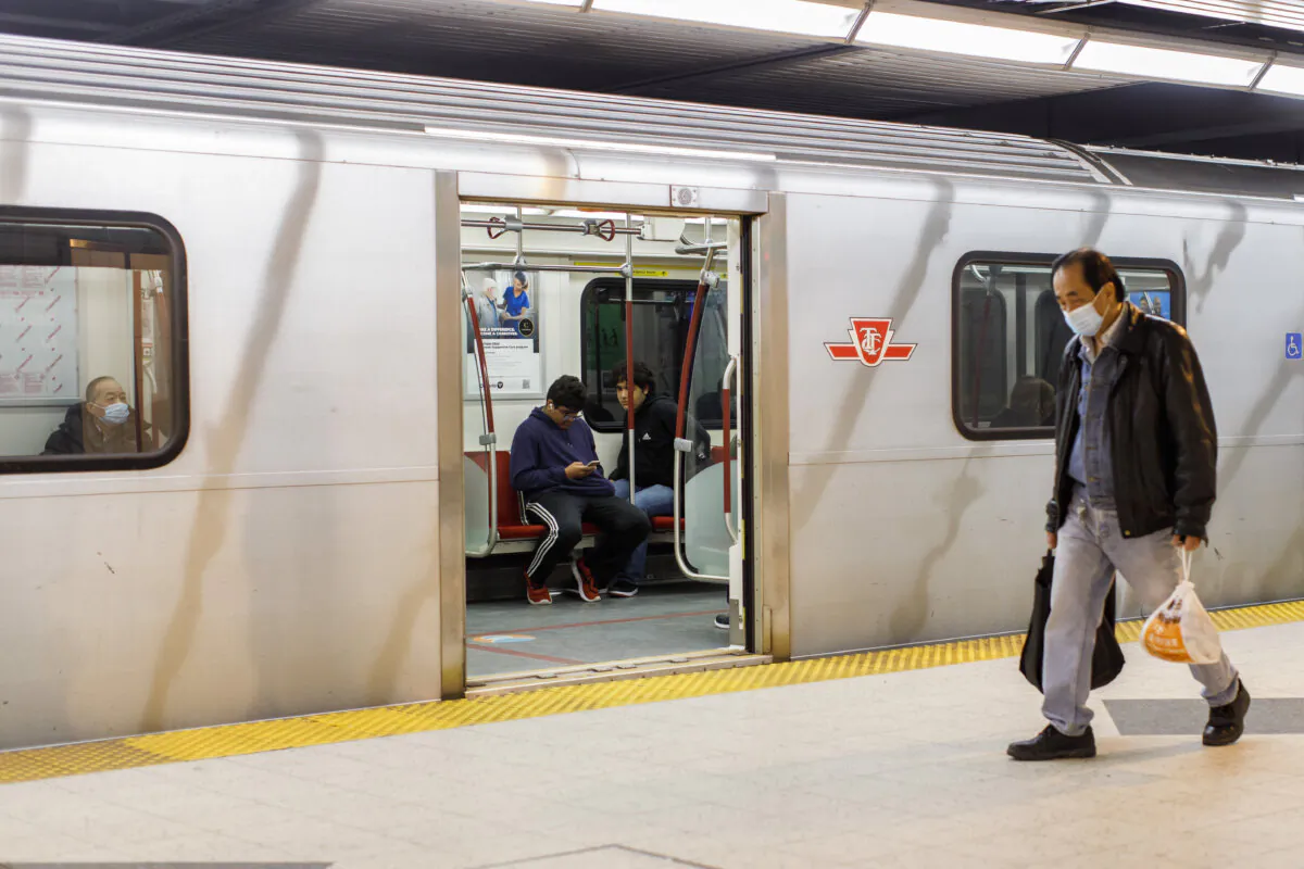 Riders take a subway train on the Toronto Transit Commission station in downtown Toronto on April 1, 2023. (The Canadian Press/Cole Burston)