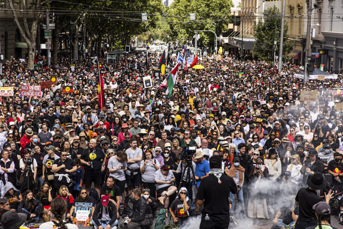 People gather outside the Victorian Parliament for the Invasion Day rally in Melbourne, Friday, January 26, 2024. (AAP Image/Diego Fedele) NO ARCHIVING