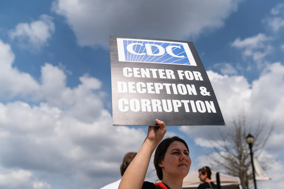 People are seen at a protest against masks, vaccines, and vaccine passports outside the headquarters of the Centers for Disease Control (CDC) in Atlanta, Ga., on March 13, 2021. (Elijah Nouvelage/Getty Images)