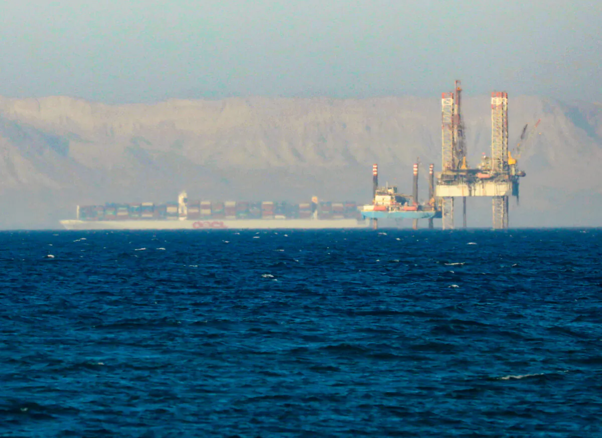 A container ship crosses an oil platform at the Gulf of Suez towards the Red Sea before entering the Suez Canal, outside of Cairo, Egypt, on Sept. 1, 2020. (Amr Abdallah Dalsh/Reuters)