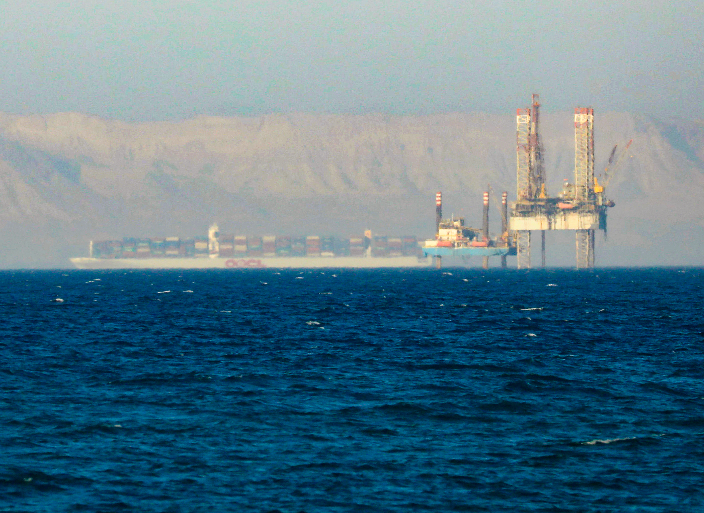 File Photo Container Ship Crosses An Oil Platform At The Gulf Of Suez Towards The Red Sea