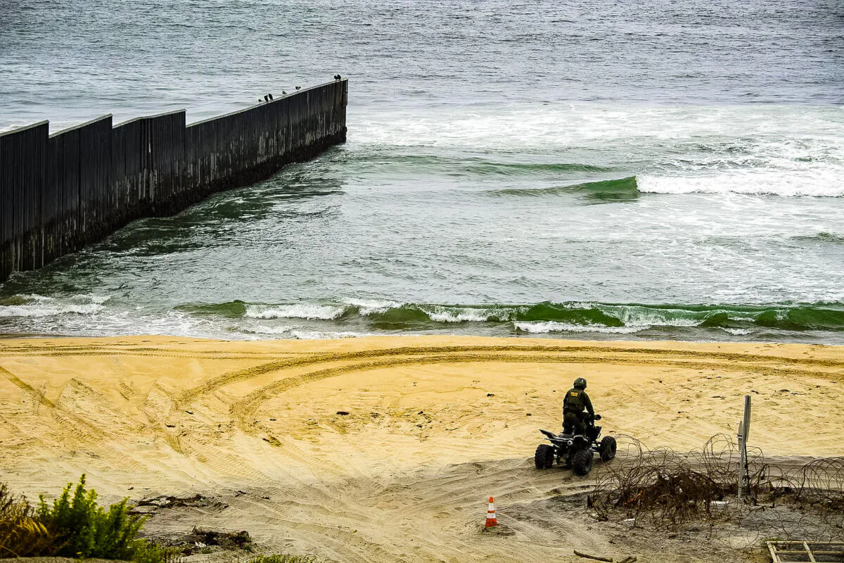 A U.S. Border Patrol agent patrols on an all-terrain vehicle where the border wall ends in the Pacific Ocean along the U.S.-Mexico border between San Diego and Tijuana, during a tour with the U.S. Customs and Border Protection at International Friendship Park in San Diego County, Calif. on May 10, 2021. (Patrick T. Fallon/AFP via Getty Images)