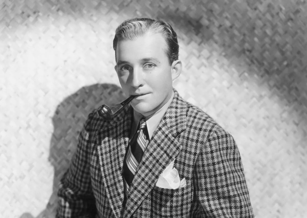 Studio portrait of American singer and actor Bing Crosby sitting and smoking a pipe, circa 1938. (Hulton Archive/Getty Images)