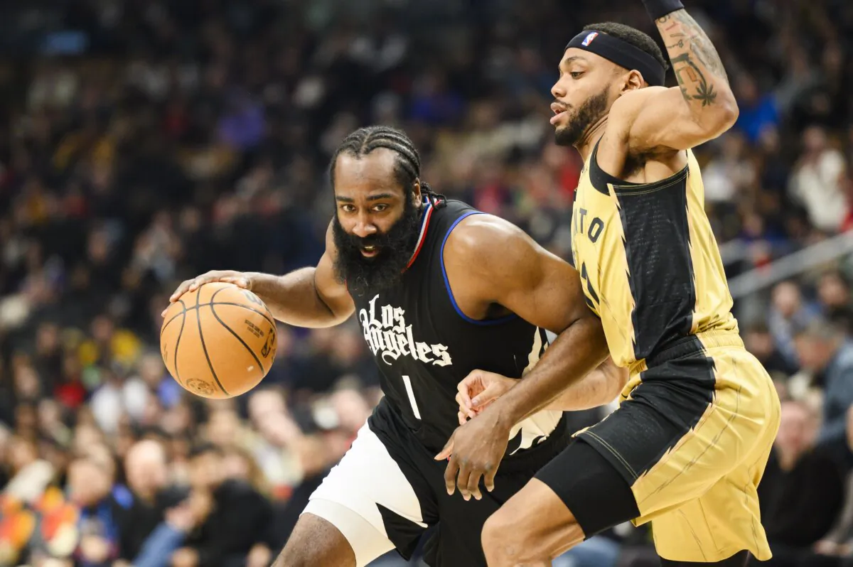 Los Angeles Clippers guard James Harden (L) drives to the net while defended by Toronto Raptors guard Bruce Brown (R) during the first half of an NBA basketball game in Toronto on Jan. 26, 2024. (Christopher Katsarov/The Canadian Press via AP)