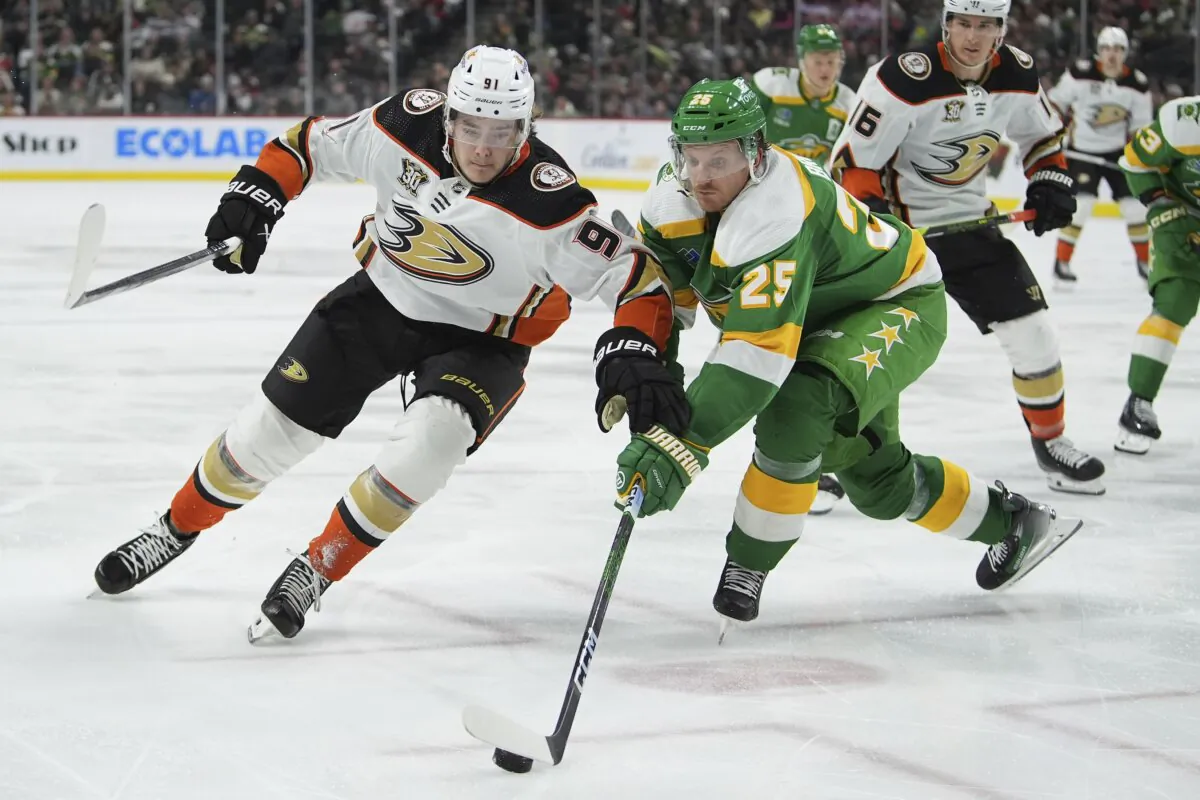 Anaheim Ducks center Leo Carlsson (L) and Minnesota Wild defenseman Jonas Brodin (25) battle for the puck during the second period of an NHL hockey game in St. Paul, Minn., on Jan. 27, 2024. (Abbie Parr/AP Photo)